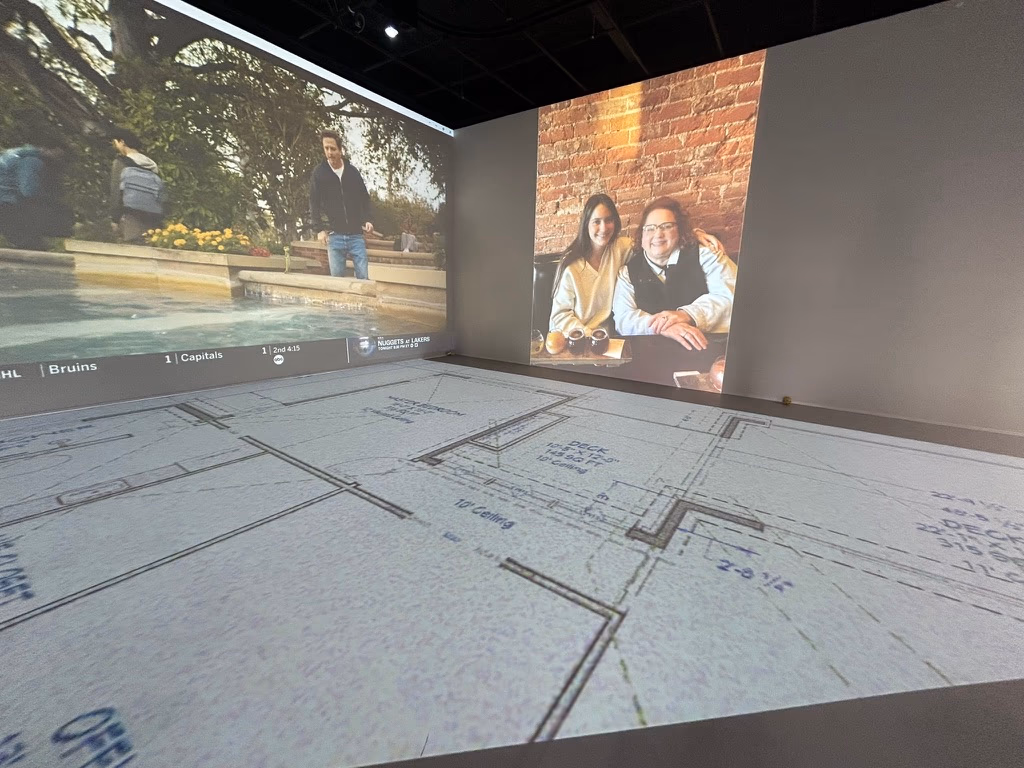 A large-scale event projected across the Walk Your Plans NWA studio canvas