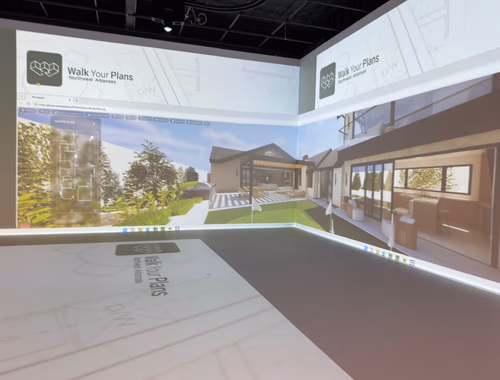 3D exterior rendering of a custom home projected onto the studio walls